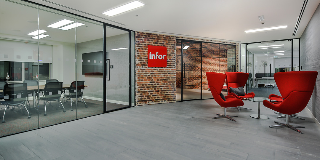 Reception area for Infor, with large comfy red seating