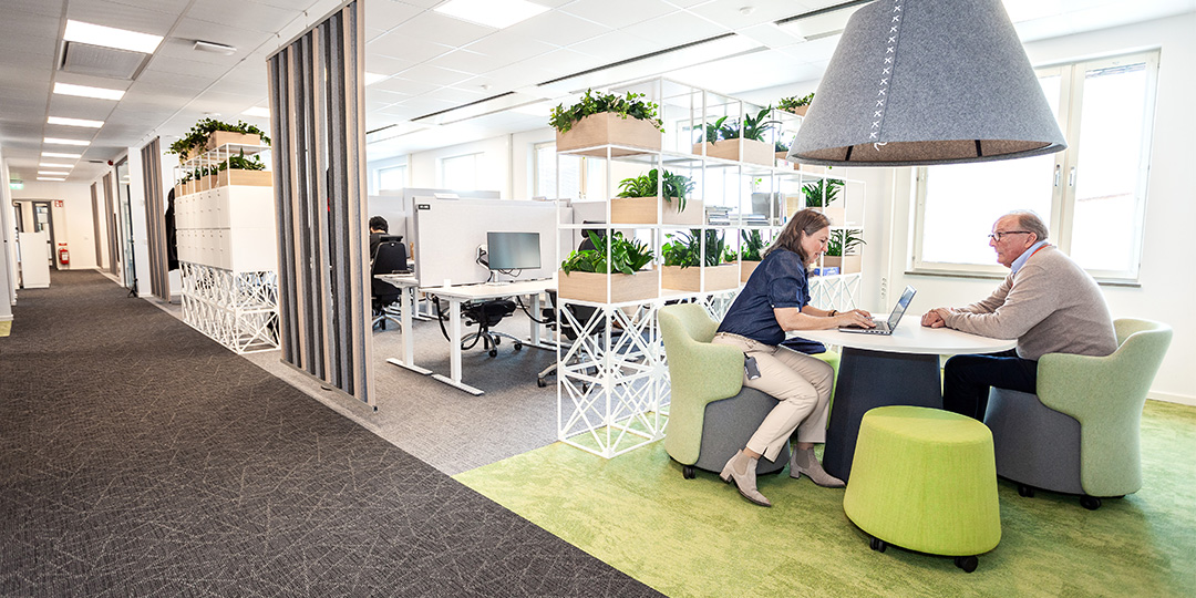 Green office furniture in open plan layout