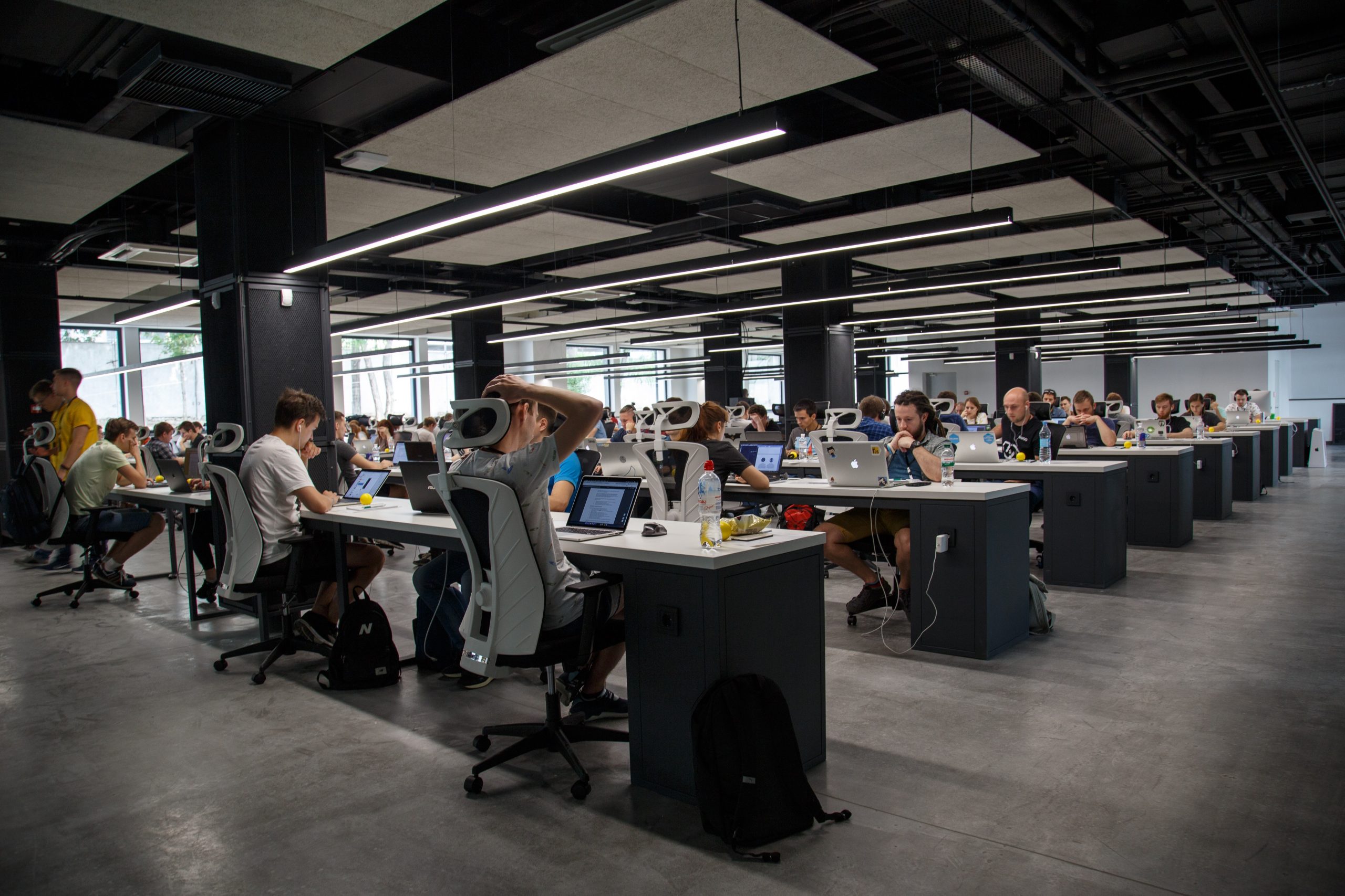 Busy office environment with many staff working at desks