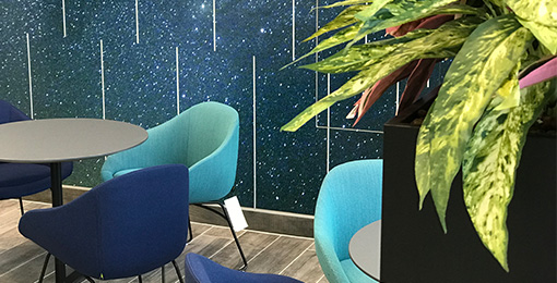 Breakout areas with blue seating curated by Mobius At Work