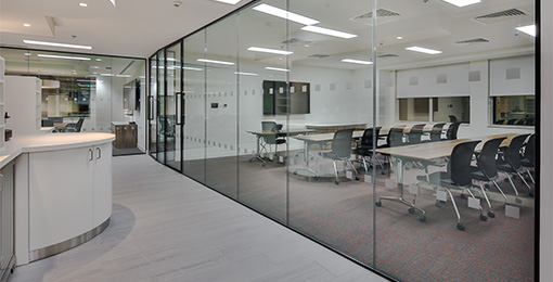 Looking through glass to a boardroom designed by Mobius At Work