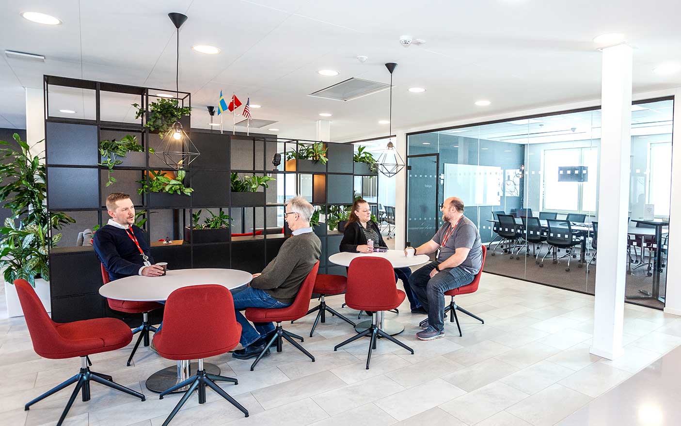 Co-workers meeting in a new office breakout area, designed by Mobius At Work