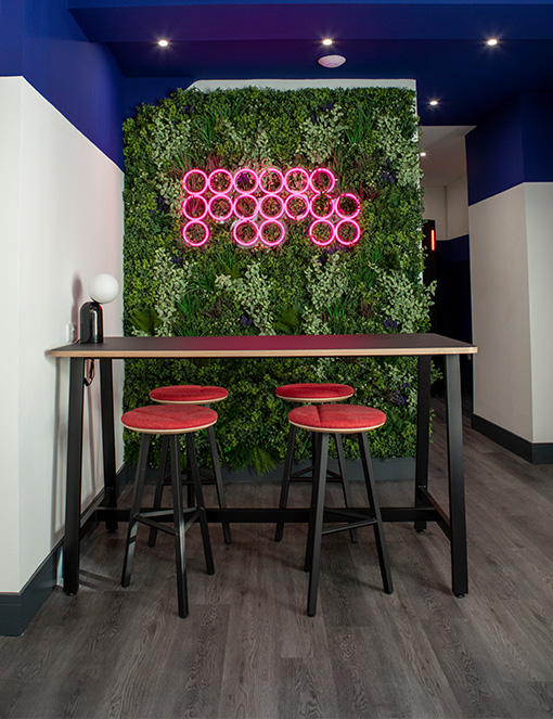 Neon pink sign in MPB breakout area