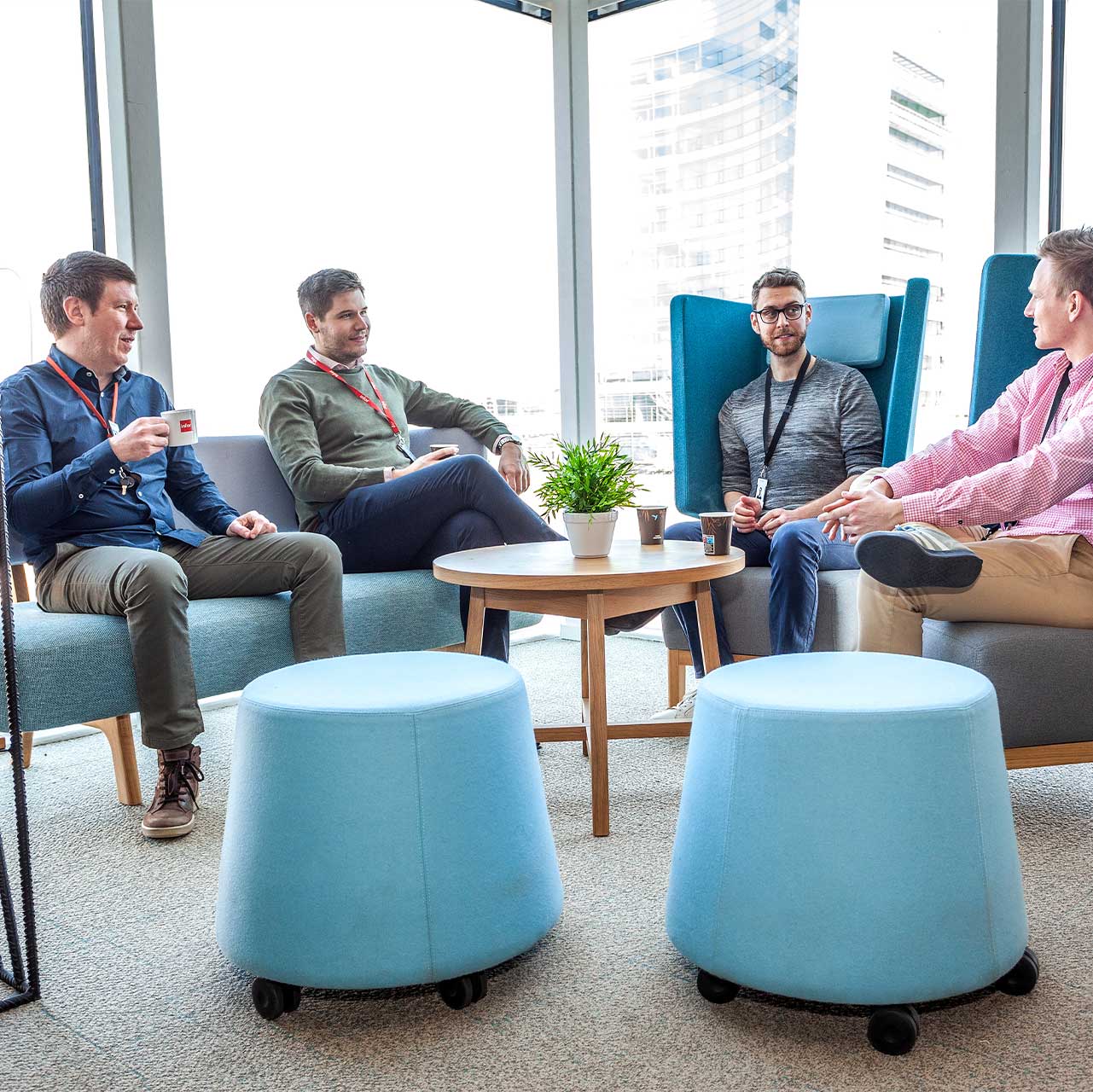 Co-workers meeting in breakout area refurbished by Mobius At Work