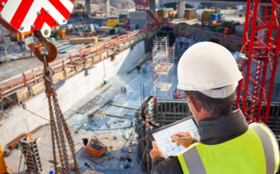 A construction worker making checks during the building phase