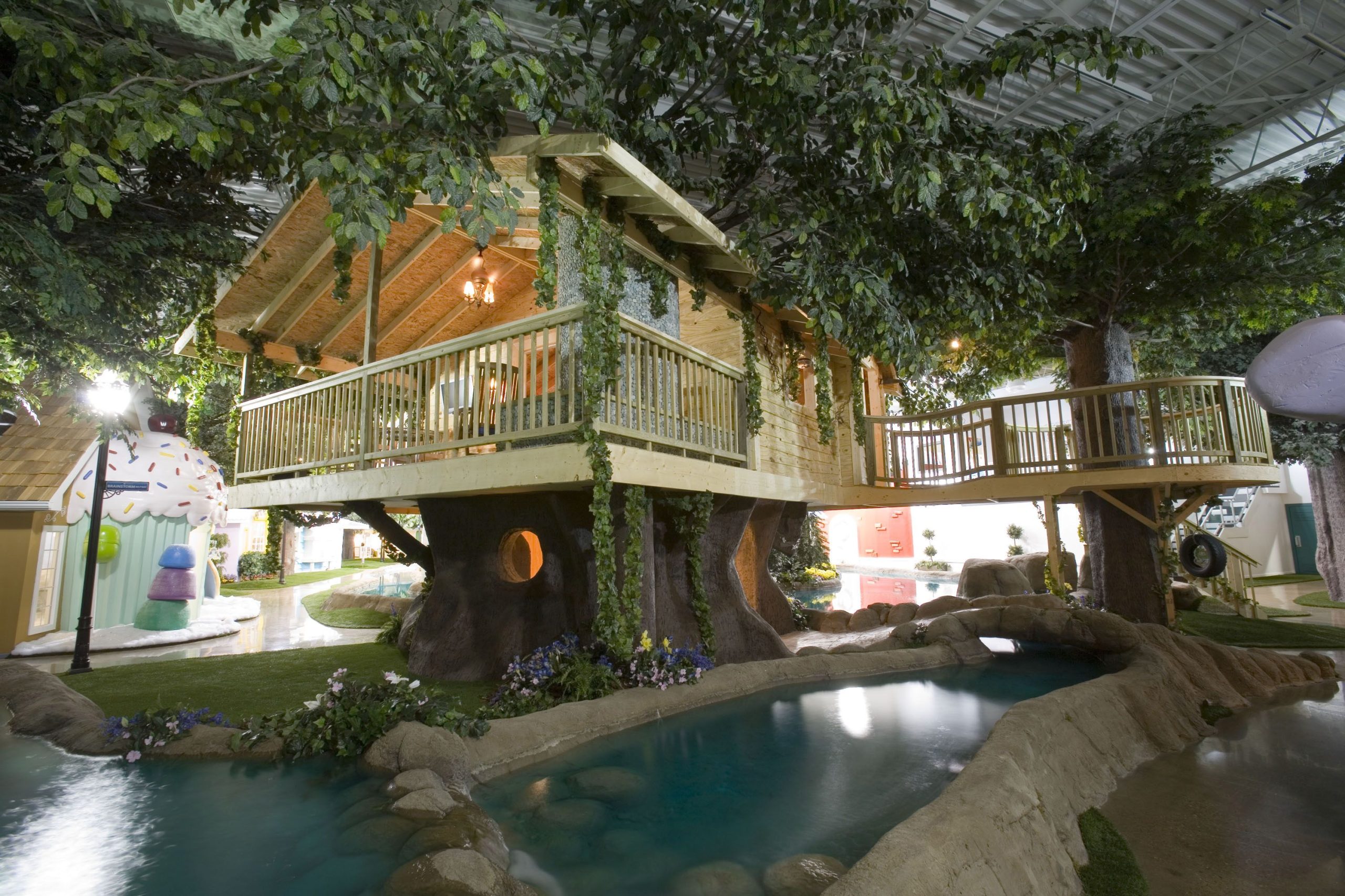 A novelty treehouse workplace above a manmade shallow lake.