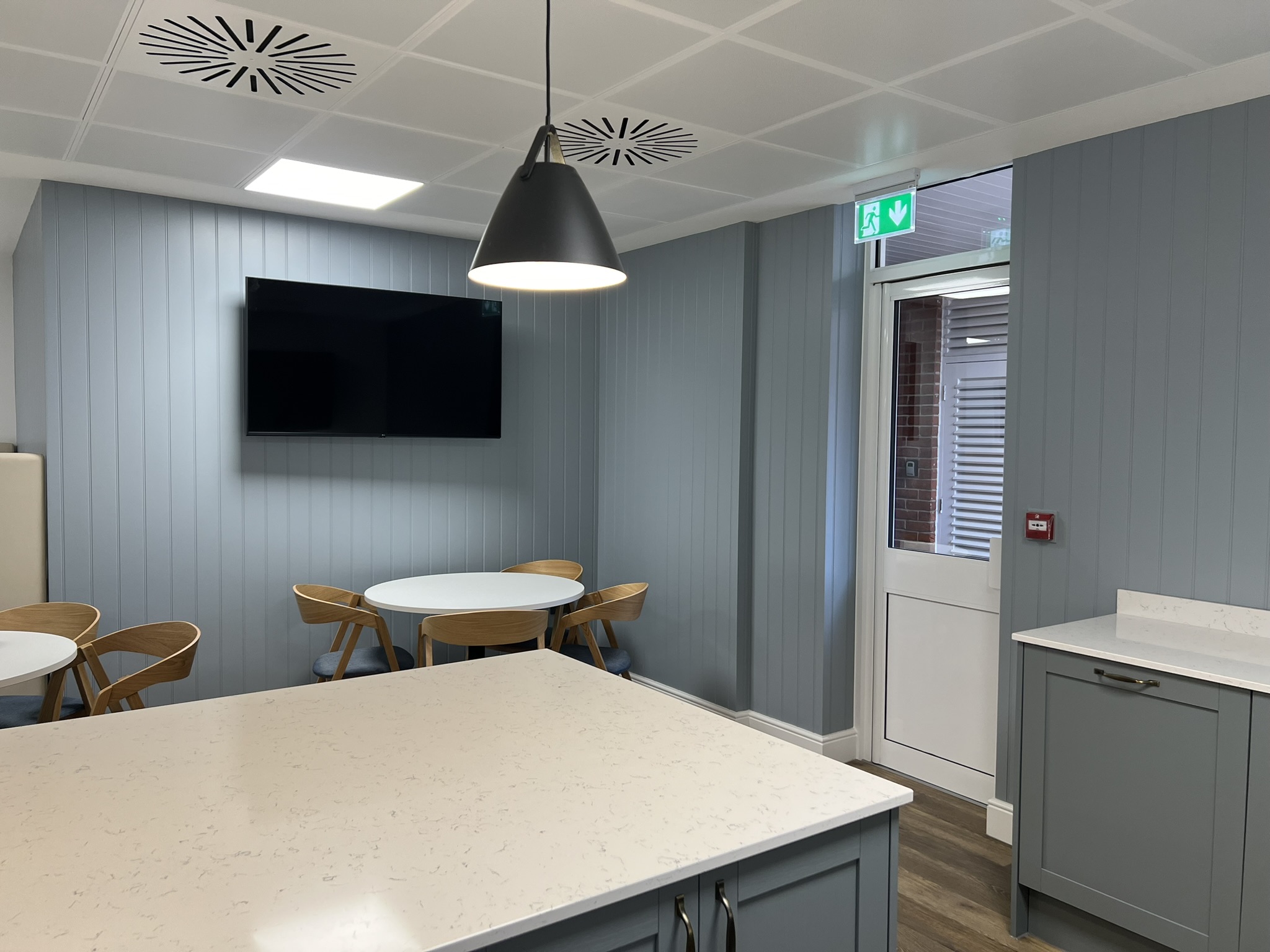 Farmhouse style kitchen in soft blue tones. Designed by Mobius At Work