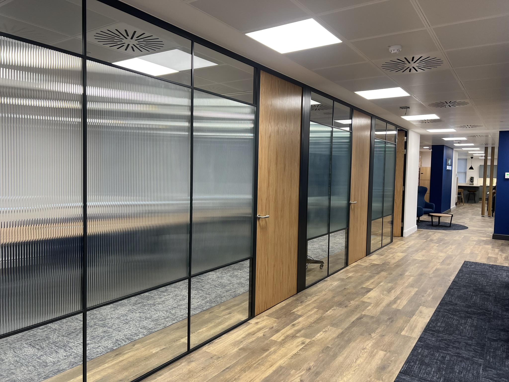 Fluted glazing to conference room with solid wood doors for acoustics