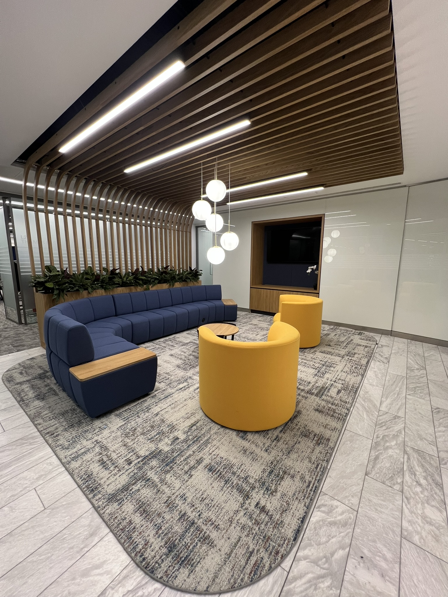 Blue modular sofa with yellow occasional chairs